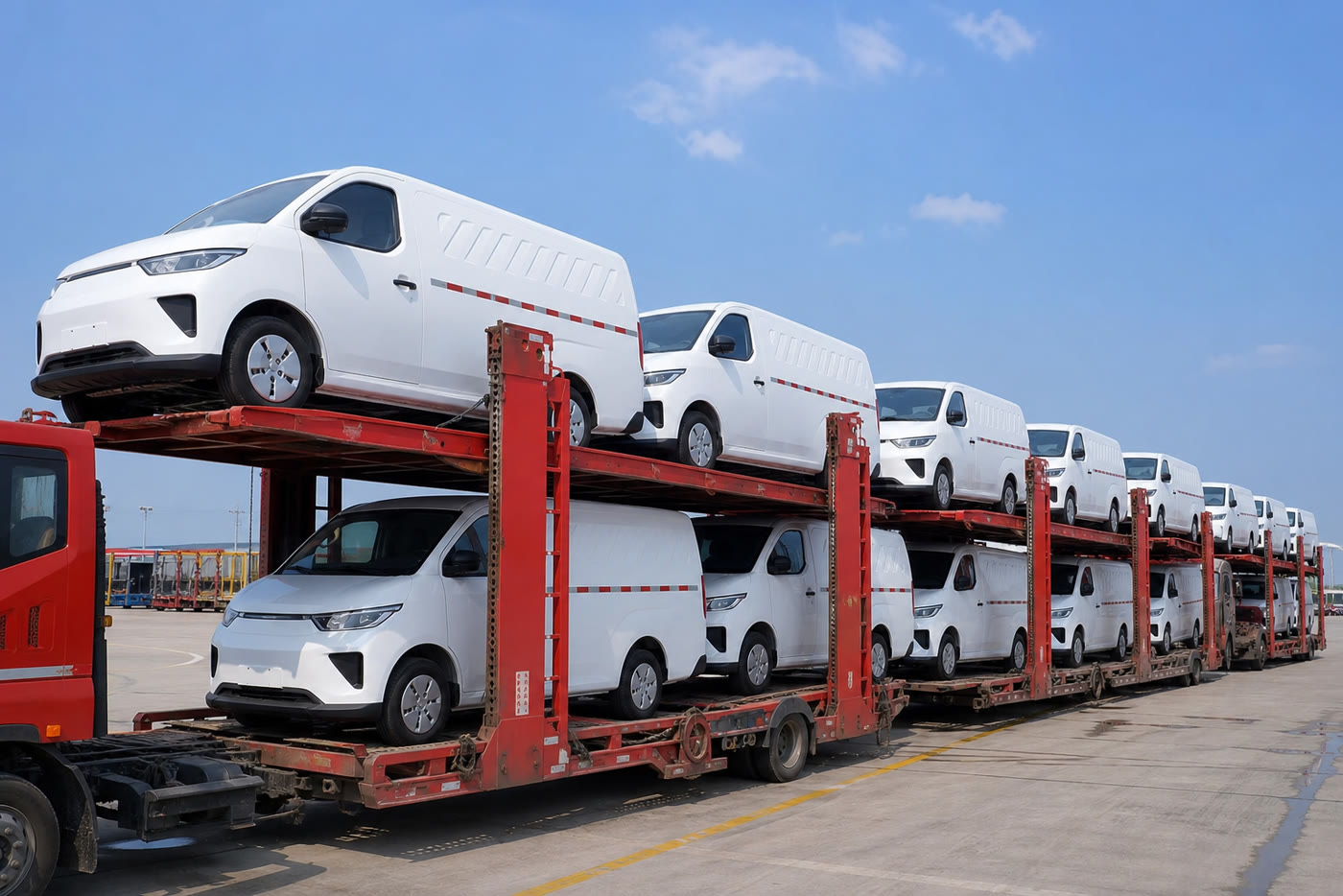 Batch of white electric cargo vans loaded onto vehicle transporters for export to Uzbekistan